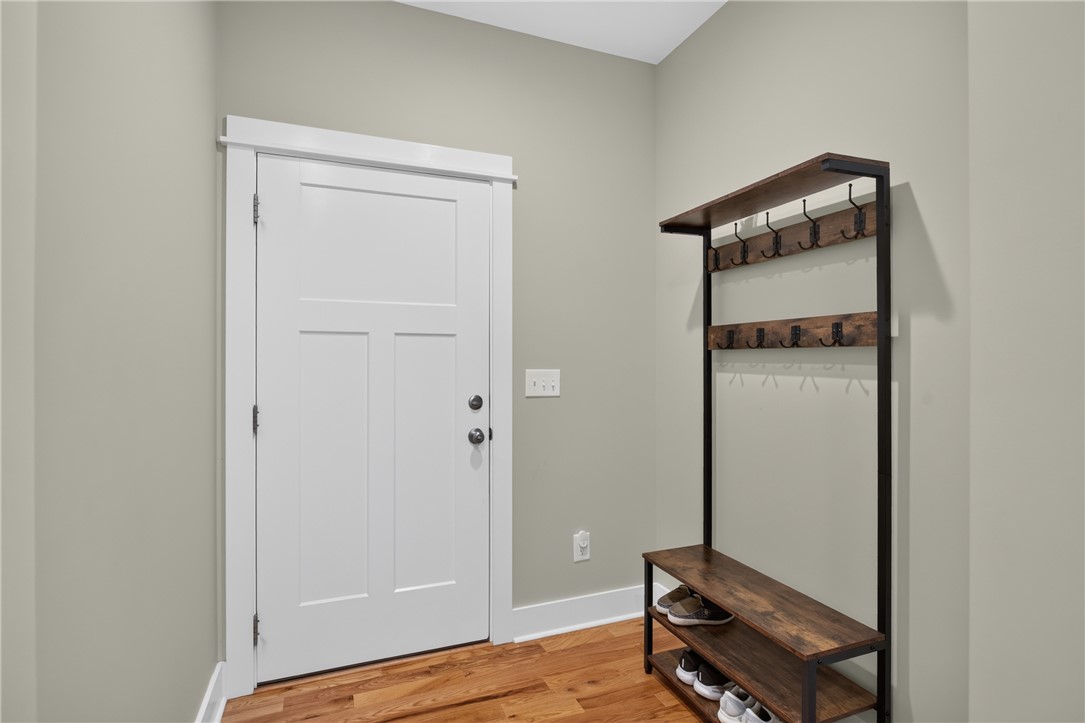405 Pawnee Drive Walhalla, SC 29691 - Photo 20 of 36 A well-lit entry with rich hardwood flooring and a functional drop space area provides a warm welcome.