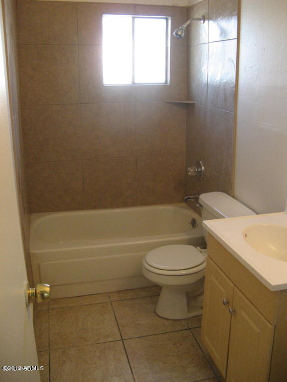 1537 West Pierce Street, Unit 2 Phoenix, AZ 85007 - Photo 3 of 3 a bathroom with a toilet a sink and bathtub