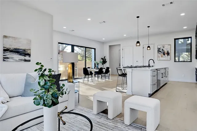 a living room with furniture potted plant and a window