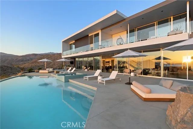 a view of swimming pool with outdoor seating and plants