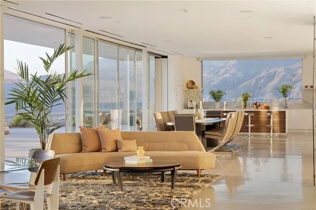 a living room with fireplace furniture and a large window