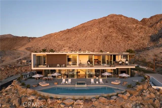 an aerial view of a house with pool table and chairs