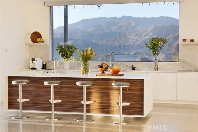 a dining room with furniture a rug and a large window