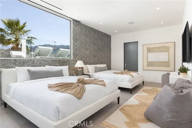 a bedroom with a large bed and a chandelier