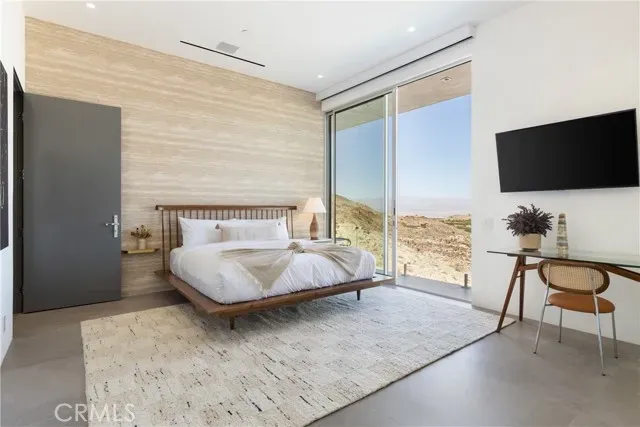 a bedroom with a large bed and a large window