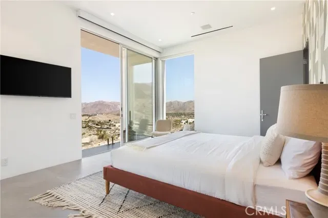 a view of a terrace with furniture and city view