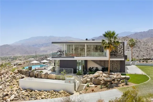 a front view of a house with a yard and seating space