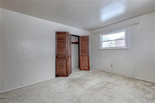 an empty room with closet area