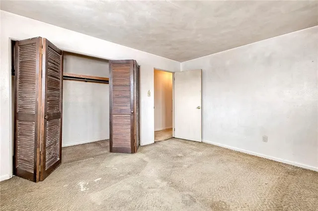 a bathroom with a tub shower and toilet