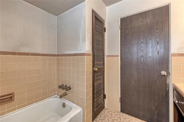 a view of empty room with a fireplace and cabinet