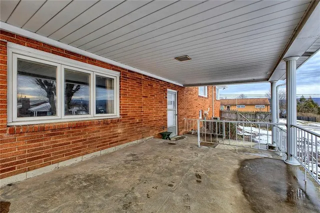 a backyard of a house with a large tree
