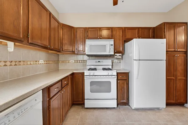 a kitchen with a refrigerator sink and cabinets