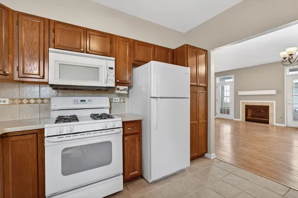 a kitchen with a stove top oven a refrigerator and cabinets