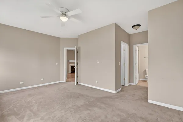 a view of an empty room with a ceiling fan