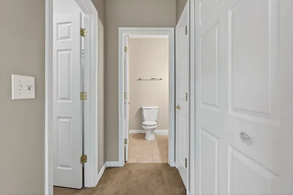a view of a bathroom from a hallway