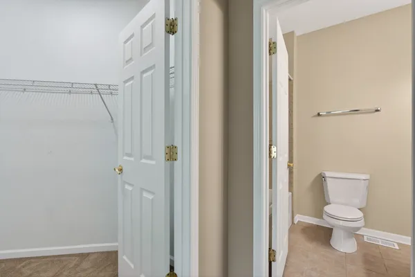 a white toilet sitting next to a bathroom sink