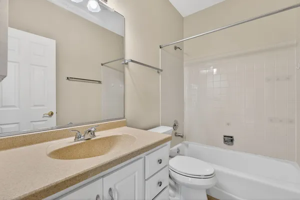 a bathroom with a sink toilet vanity and shower