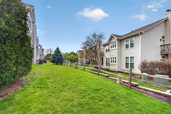 a view of a house with a yard and sitting area