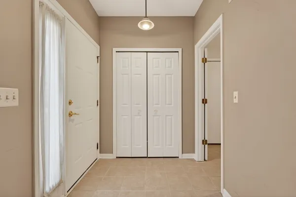 a view of a hallway with wooden door