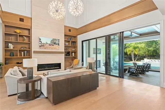 a living room with furniture a floor to ceiling window and a flat screen tv