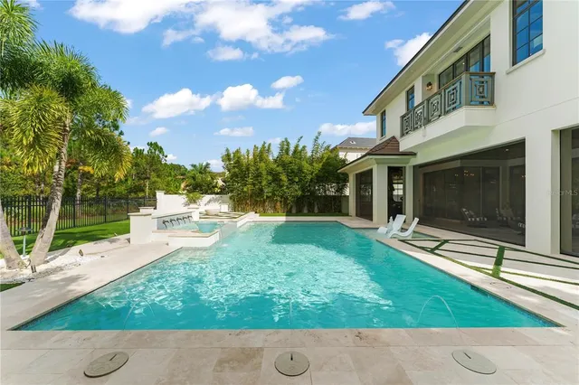 a view of backyard with a garden and fire pit