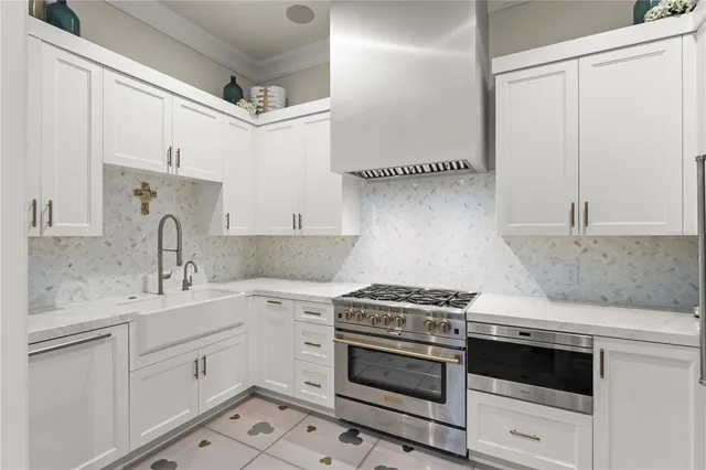 a kitchen with cabinets appliances and a sink