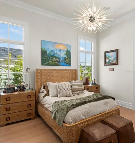 a bedroom with a bed dresser and a window