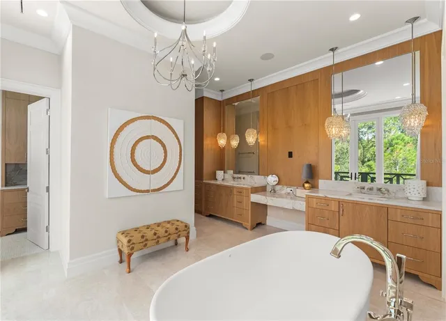 a large white kitchen with a large window