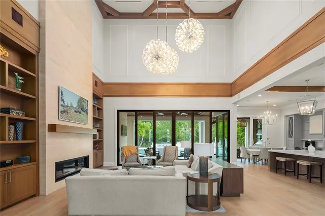 a living room with fireplace furniture and a large window