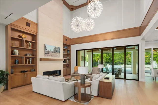 a living room with furniture and a floor to ceiling window