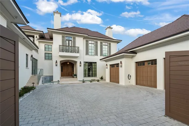 a view of a house with large windows and a ceiling fan