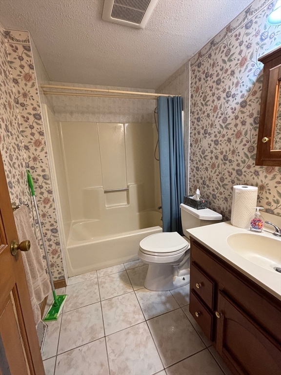 241 Broadway Road, Unit 53 Dracut, MA 01826 - Photo 12 of 24 a bathroom with a sink a toilet and shower
