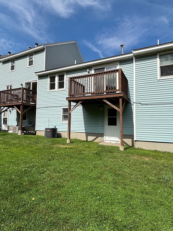 241 Broadway Road, Unit 53 Dracut, MA 01826 - Photo 20 of 24 a view of a house with a yard