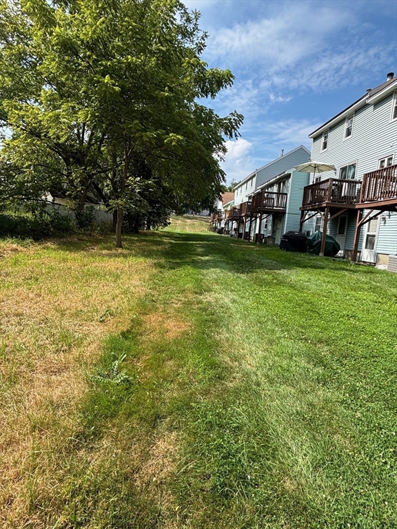 241 Broadway Road, Unit 53 Dracut, MA 01826 - Photo 23 of 24 a view of a house with a yard