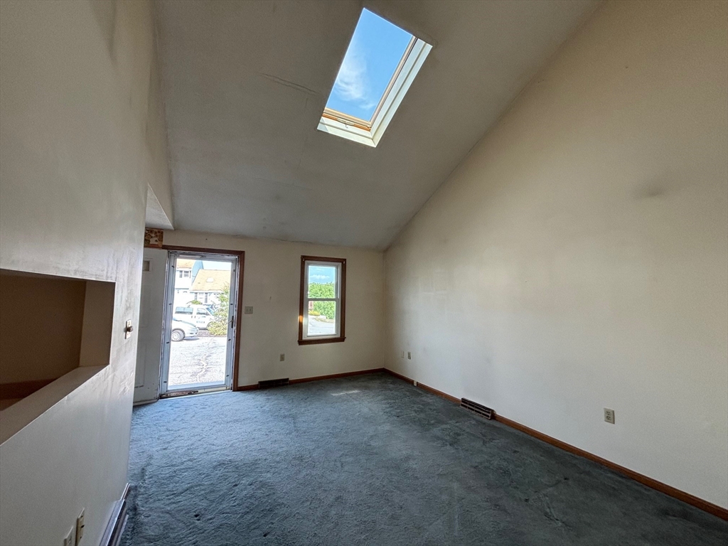 241 Broadway Road, Unit 53 Dracut, MA 01826 - Photo 6 of 24 a view of empty room with windows