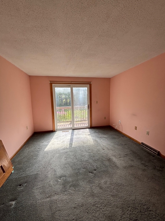 241 Broadway Road, Unit 53 Dracut, MA 01826 - Photo 10 of 24 a view of an empty room with a window