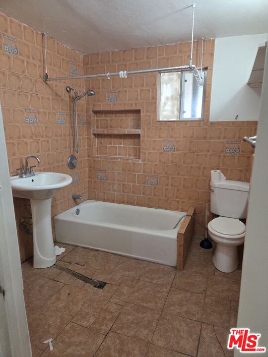 1612 Arlington Avenue Los Angeles, CA 90019 - Photo 10 of 24 a bathroom with a sink a toilet and shower