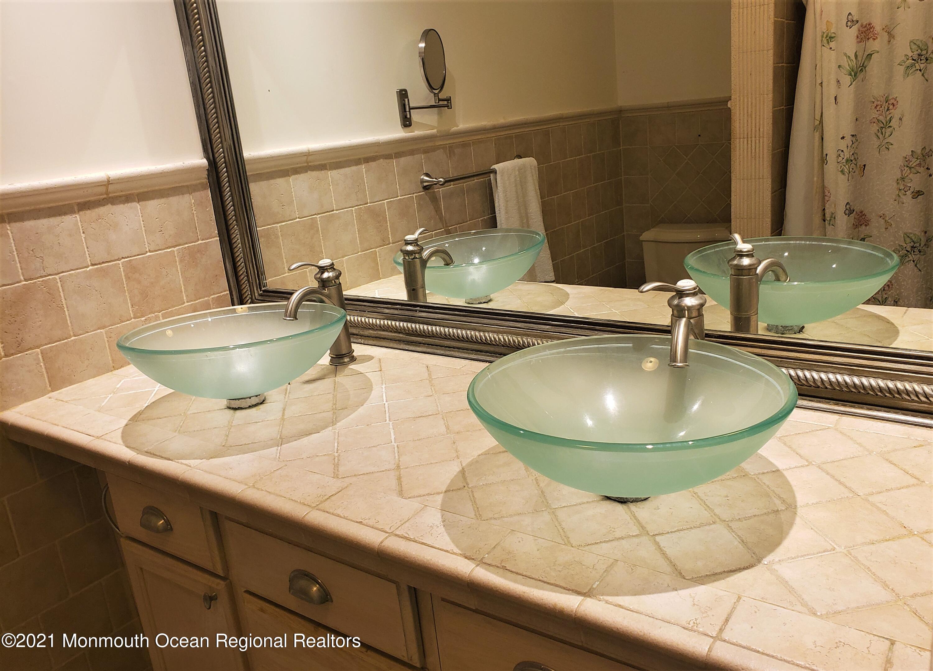 164 Linden Avenue, Unit 12 Highlands, NJ 07732 - Photo 5 of 8 a bathroom with a sink and a mirror