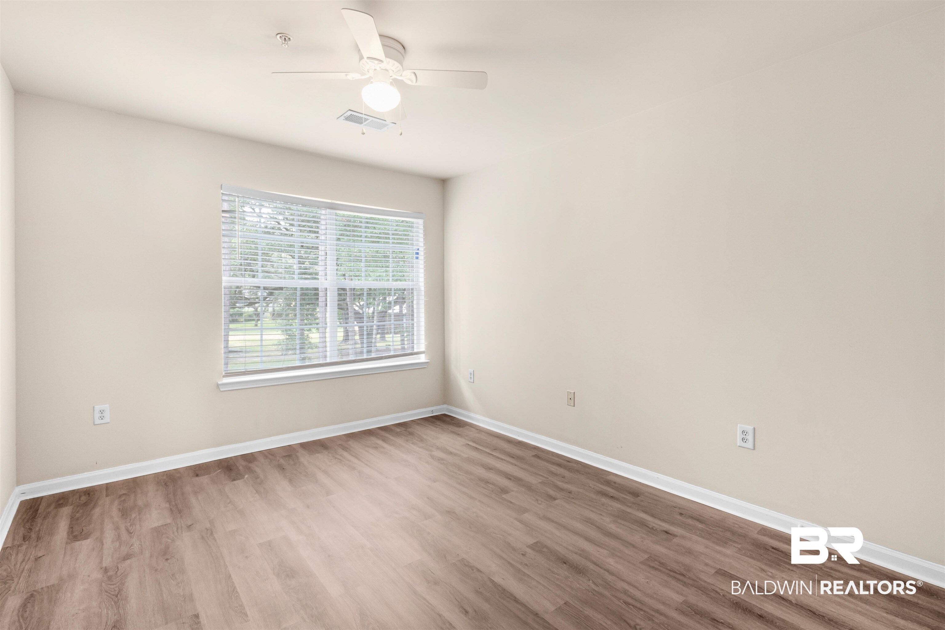 1517 Regency Road, Unit 85 Gulf Shores, AL 36542 - Photo 13 of 32 Spare room featuring hardwood / wood-style flooring and ceiling fan