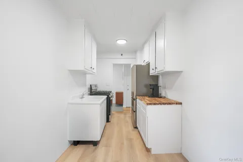 a kitchen with stainless steel appliances a stove top oven