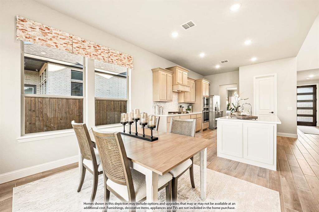 5422 Rutherford Drive Midlothian, TX 76065 - Photo 10 of 36 a dining room with a table chairs and a kitchen view