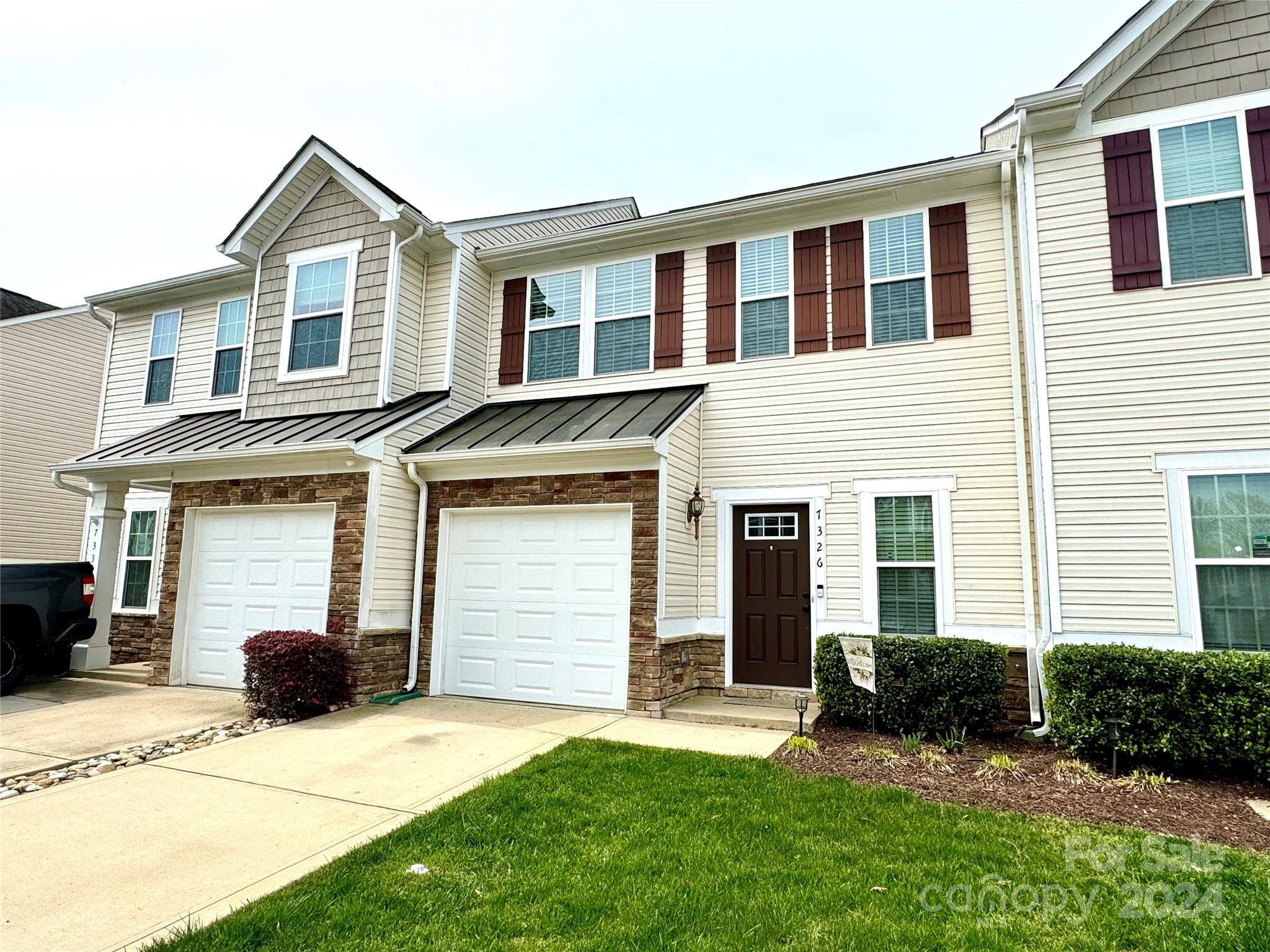 7326 Copper Beech Trace Charlotte, NC 28273 - Photo 1 of 29 a front view of a house with a yard and garage