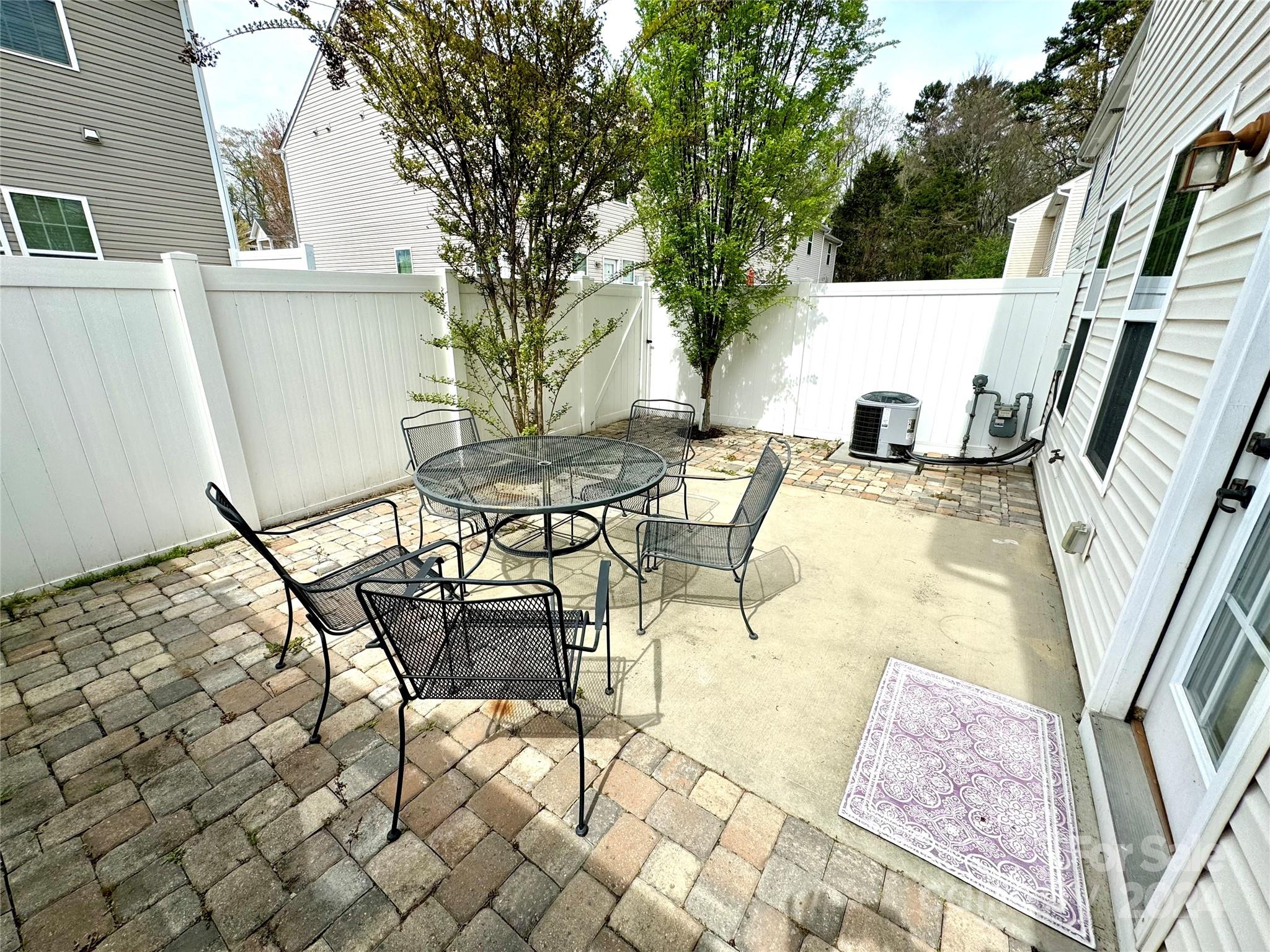7326 Copper Beech Trace Charlotte, NC 28273 - Photo 24 of 29 a view of a patio with table and chairs with wooden floor and fence