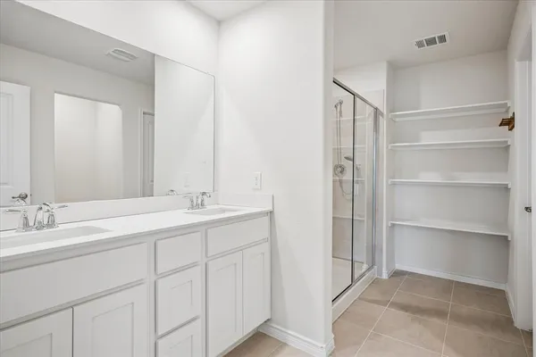 a bathroom with a double vanity sink and mirror