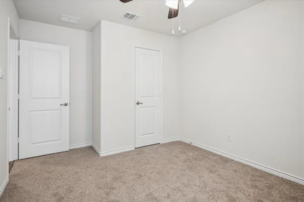 an empty room with a ceiling fan