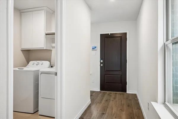 a view of hallway with wooden floor