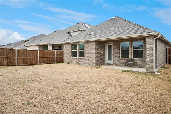 a view of a house with a wooden fence