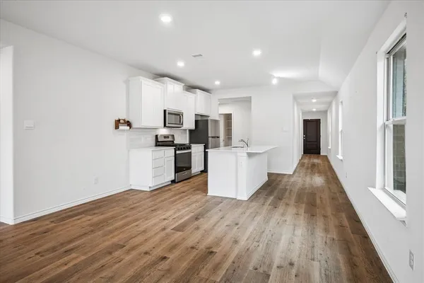 a view of a kitchen with wooden floor