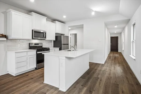a kitchen with a sink microwave and refrigerator