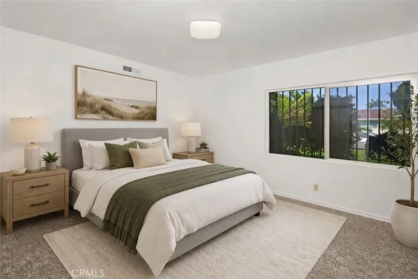 a bedroom with a large bed and a large window
